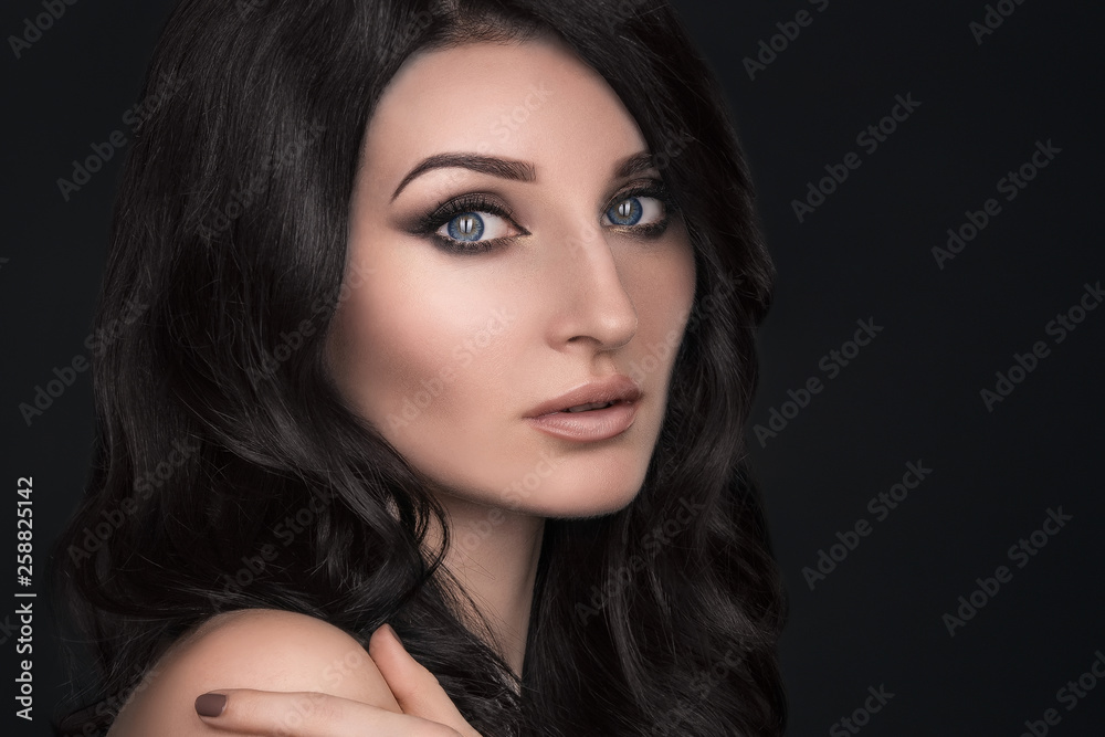 Portrait of a sexy brunette with an elegant hairstyle and evening makeup Portrait of a sexy brunette with an elegant hairstyle and evening makeup