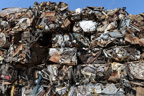 Large stack of compacted scrap metal blocks for scrap metal recycling in the USA.