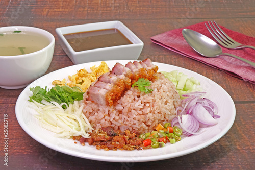 Fried rice with shrimp paste (Khao khluk Kapi) is a flavorful dish in Thai cuisine that consists of primary ingredients of fried rice mixed with shrimp paste (Kapi),  typically served as a lunch dish. photo