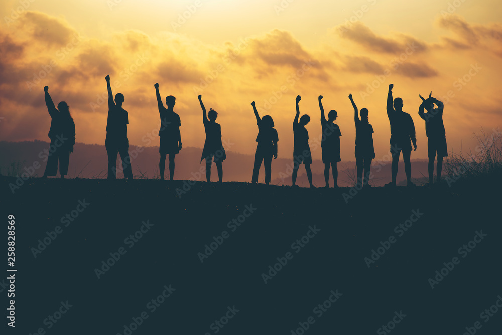 Success of teamwork collaboration and freedom on silhouette sunset background. business concept Success of teamwork collaboration and freedom on silhouette sunset background. business concept