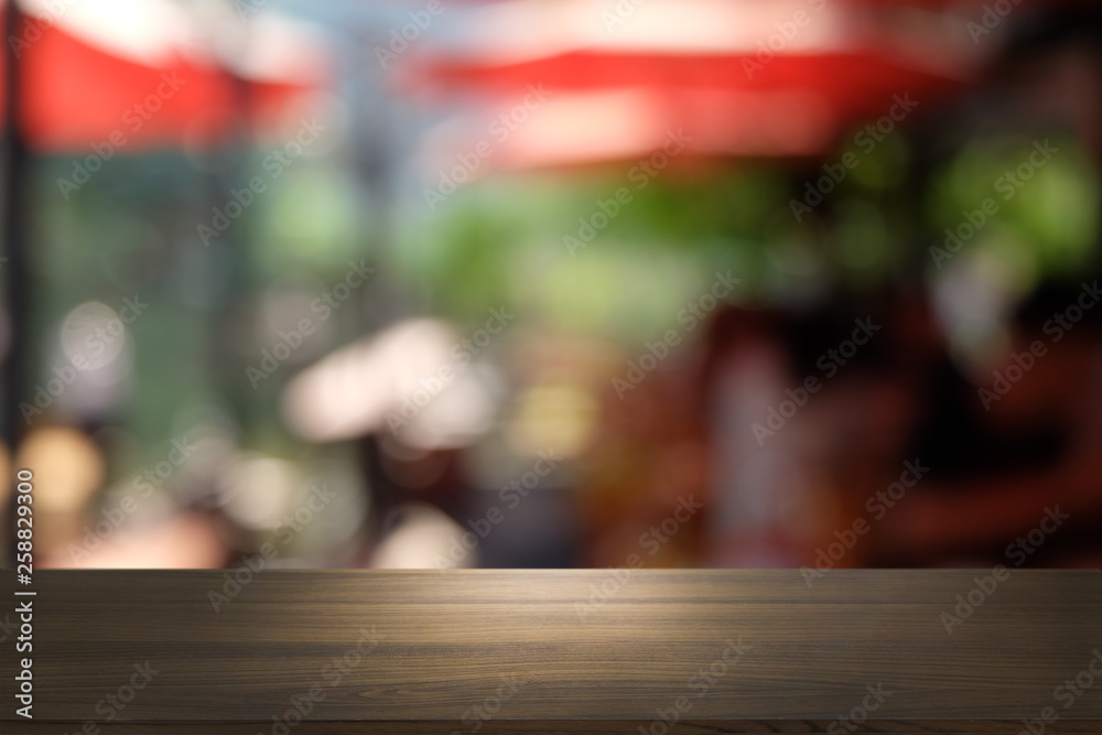 Empty dark wooden table in front of abstract blurred bokeh background of restaurant . can be used for display or montage your products.Mock up for space. Empty dark wooden table in front of abstract blurred bokeh background of restaurant . can be used for display or montage your products.Mock up for space.