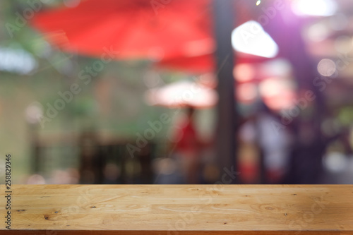 Empty dark wooden table in front of abstract blurred bokeh background of restaurant . can be used for display or montage your products.Mock up for space. © Wanda