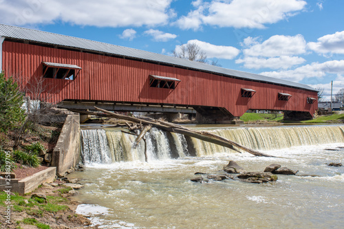 A logjam is seen under a fall near a covered bridge in Bridgeton, Indiana photo