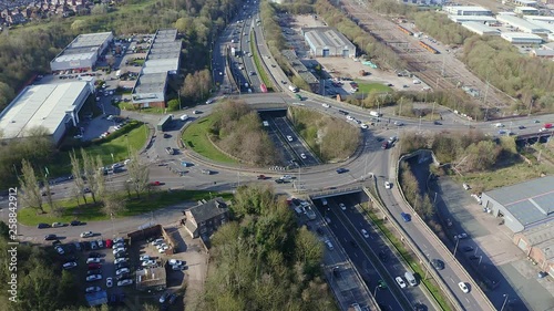 Aerial footage of a large section of commuter motorway, highway, during busy congestion, traffic, rush hour. 10 way street intersection circle roundabout route highway called the A50, A500 photo