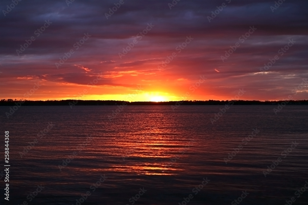Sunset sky with clounds colors in a lake view, soft blurry background, Of free space for your texts and branding.