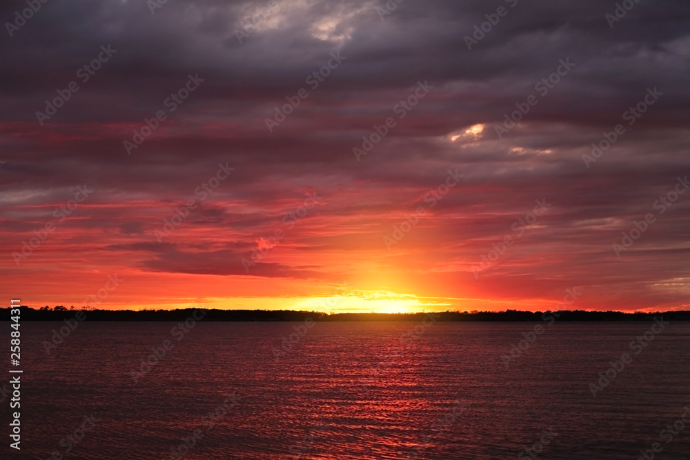 Sunset sky with clounds colors in a lake view, soft blurry background, Of free for your space and branding.
