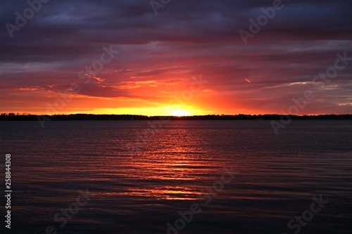 Sunset sky with clounds colors in a lake view, soft blurry background, Of free space for your texts and branding.