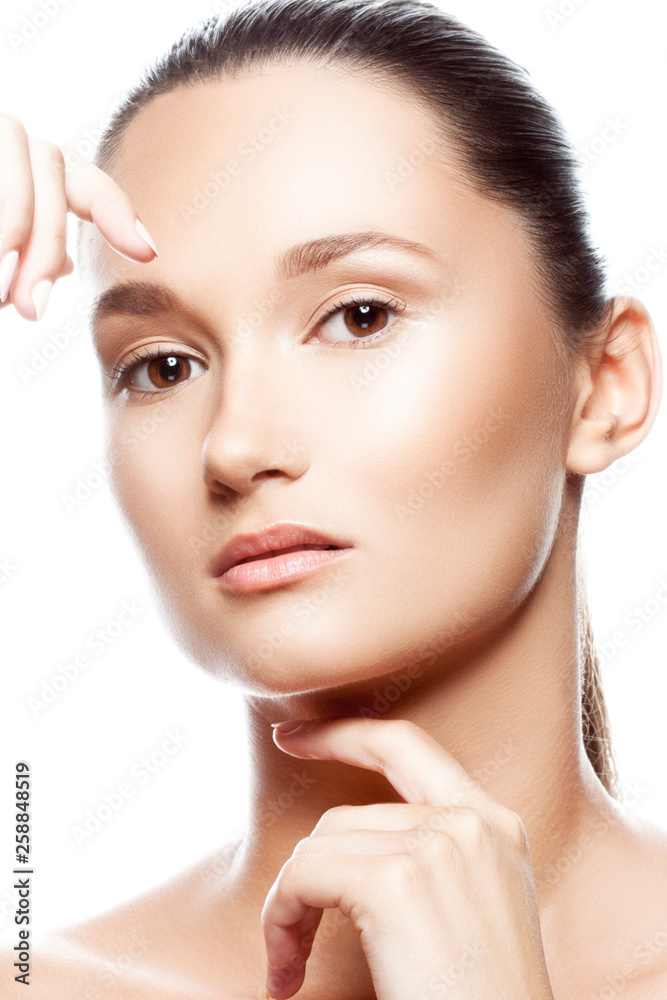 Close-up beauty studio portrait of young Caucasian attractive pretty young woman. Clean skin, hair style, nude day makeup. White background