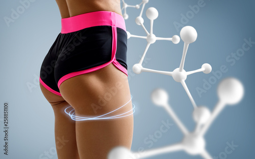 Athletic woman standing near white molecule chain.