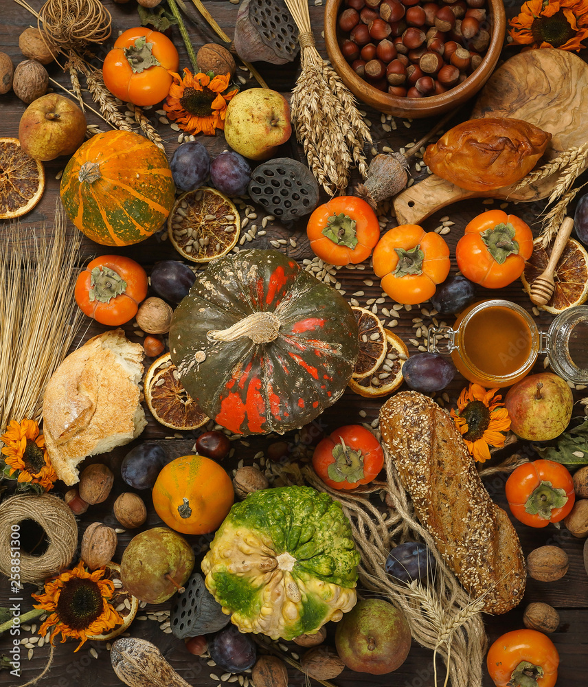 Pumpkins, persimmon, cereals, bread, seeds and nuts on a wooden background, Harvest, Autumn Pumpkins, persimmon, cereals, bread, seeds and nuts on a wooden background, Harvest, Autumn