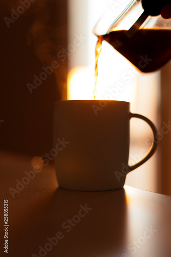 Close-up image of pouring coffee in a mug