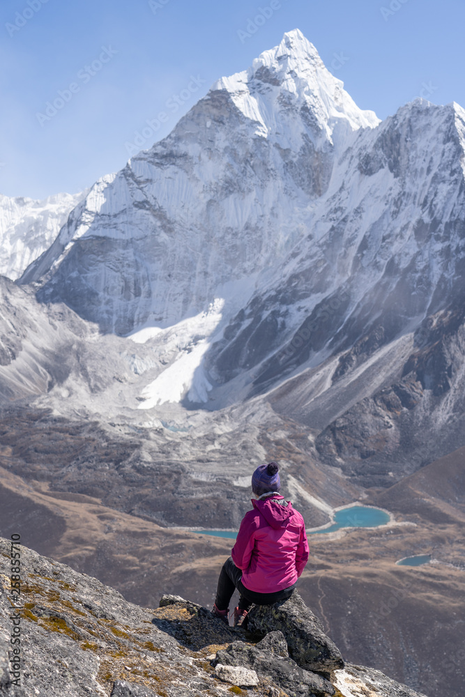 Fototapeta premium Trekker enjoy view of Ama Dablam mountain on top of Nangkart Shank view point, Himalayas mountain, Nepal