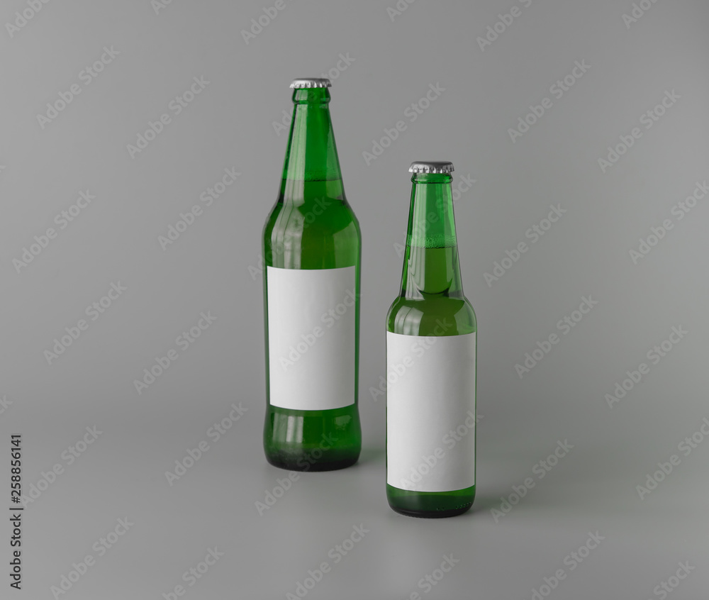 Glass green Beer with blank white label on grey background for print design and mock up Glass green Beer with blank white label on grey background for print design and mock up