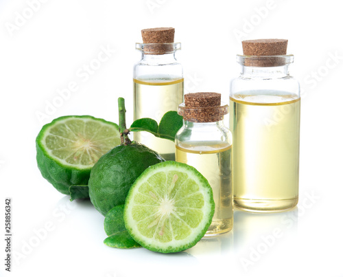 Fresh bergamot fruit and bergamot essential oil in glass bottle on white background