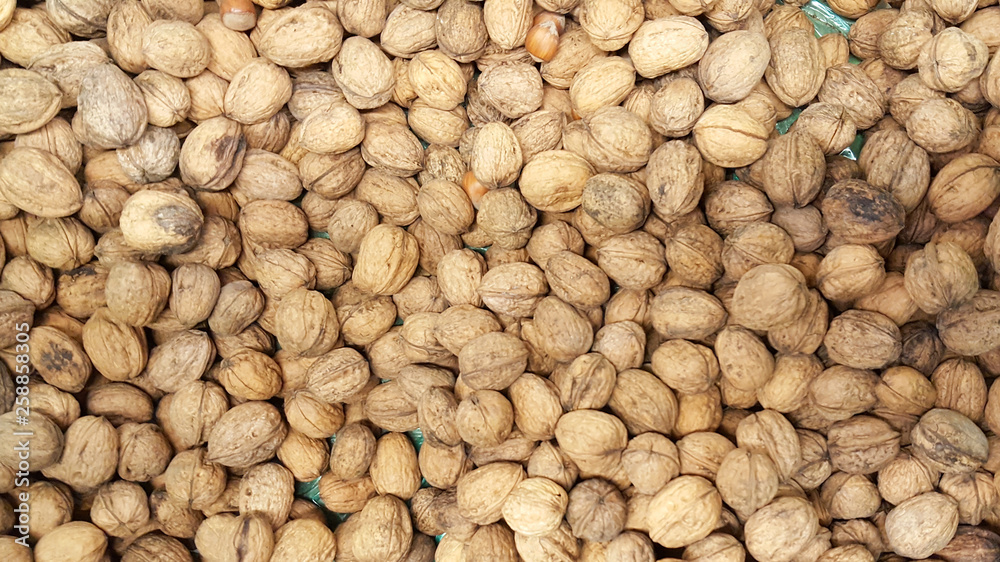Top view many walnuts nutshells in full screen background texture