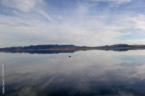 Lake reflection symetri a sunny but cold day photo