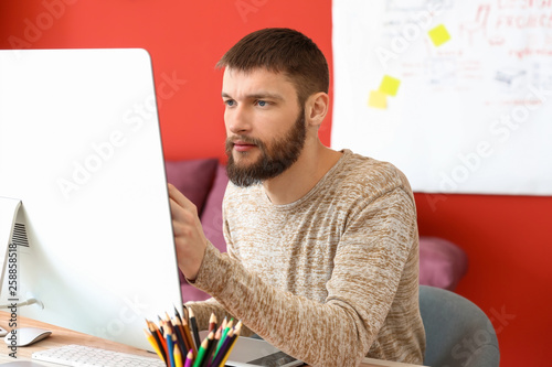 Male designer working in of...