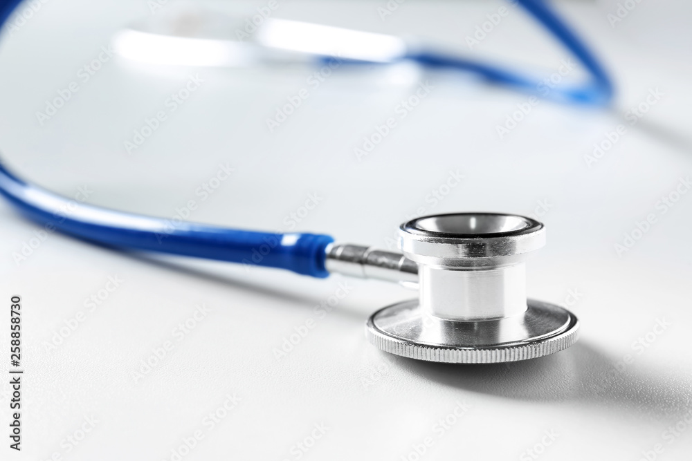 Medical stethoscope on white table, closeup Medical stethoscope on white table, closeup