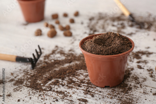 Brown plastic pot filled wi...