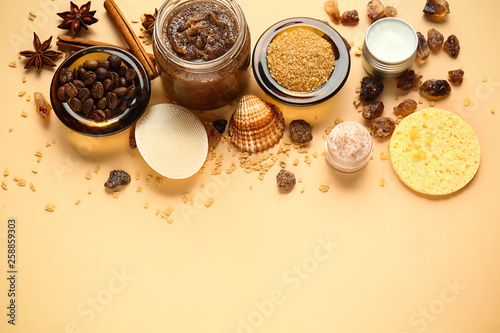 Sugar scrubs with ingredients on color background