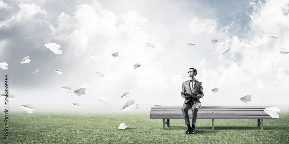 Young businessman or student studying the science and paper planes fly around Young businessman or student studying the science and paper planes fly around