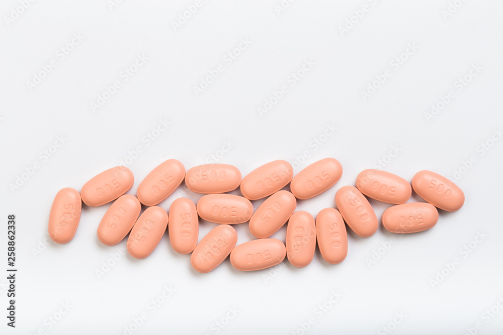 set of pink tablets on a white background set of pink tablets on a white background