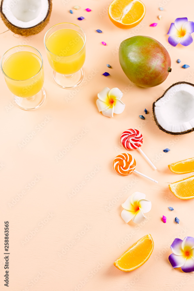 Colorful summer concept flat lay with fresh juice, tropical fruits, lollipops and multicolor seashells, copyspace Colorful summer concept flat lay with fresh juice, tropical fruits, lollipops and multicolor seashells, copyspace