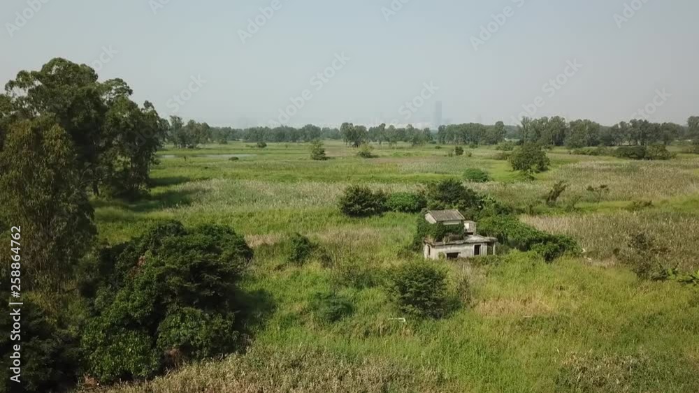 Aerial shot, little wrecked stone house in the middle of the bush, track on the house rotating angle from the front (wider angle) Aerial shot, little wrecked stone house in the middle of the bush, track on the house rotating angle from the front (wider angle)
