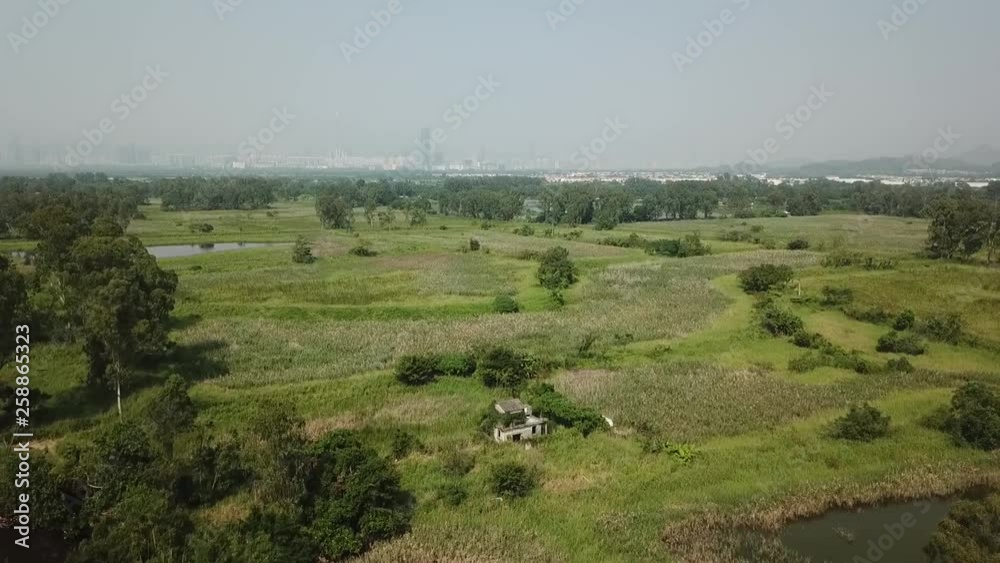Aerial shot, little wrecked stone house in the middle of the bush, track on the house in wide angle, rising up to see the panoramic view Aerial shot, little wrecked stone house in the middle of the bush, track on the house in wide angle, rising up to see the panoramic view