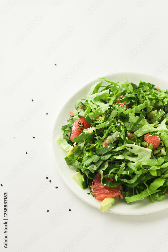 Healthy green vegan salad with grapfruit in white plate Healthy green vegan salad with grapfruit in white plate