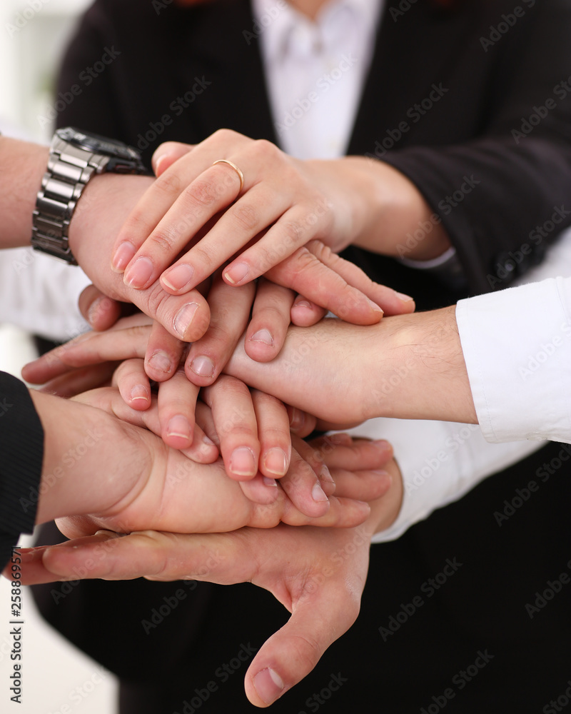 Group of people in suits crossed hands pile Group of people in suits crossed hands pile