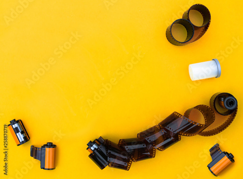 Flat lay black vintage film on yellow paper background