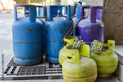 Multi-colored and different-sized gas cylinders on the street.  Bottles with liquefied petroleum gas (LPG), Propane-butane for home use. Jimbaran, Bali.