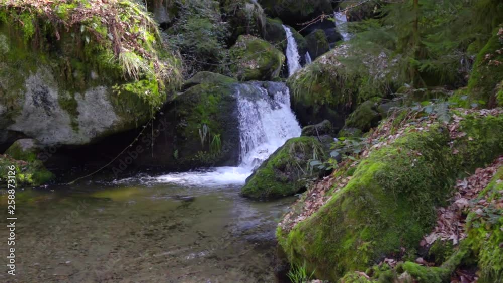beautiful mountain waterfall, clean fresh water flows over large green mossy stones in Slow motion beautiful mountain waterfall, clean fresh water flows over large green mossy stones in Slow motion