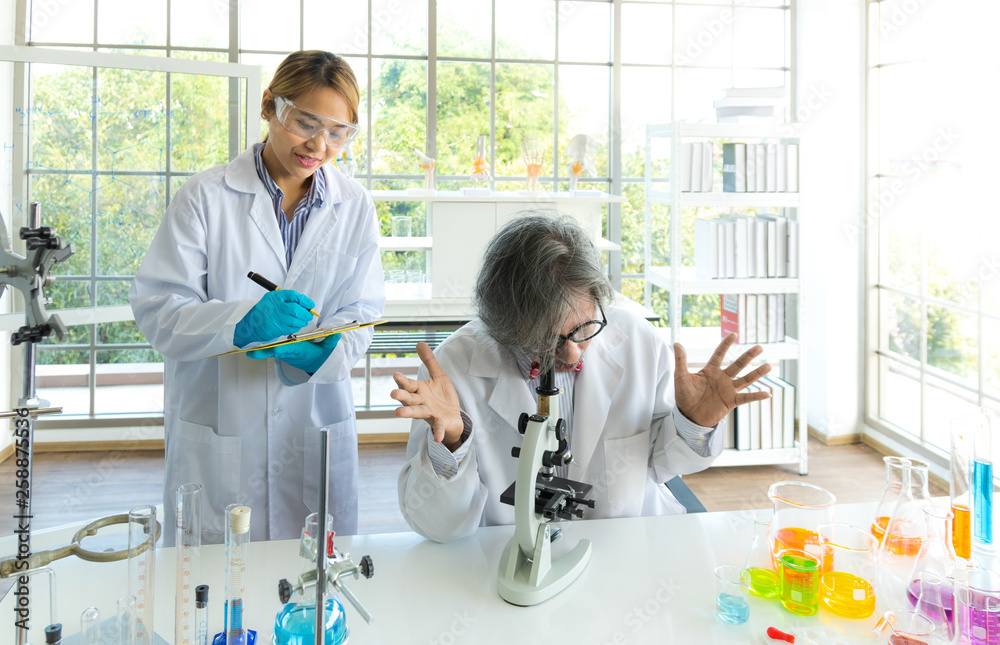 Obraz premium Young female research scientist and Senior male professor researchers working in life scientific laboratory.