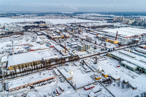 View of the urban industrial district from the air. Winter cityscape.