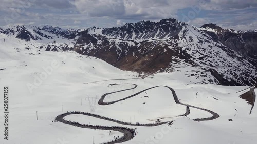 Passo dello Stelvio Aerial 2017. Cyclists and fans at the bike race.Snowy mountains
