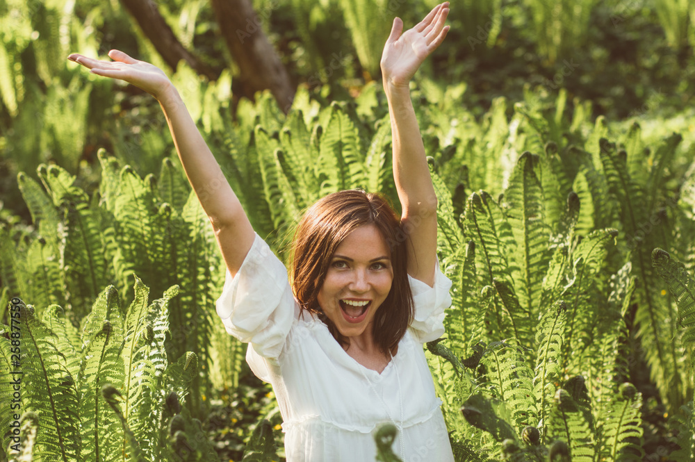 Beautiful delight brunette girl hands up in fern Beautiful delight brunette girl hands up in fern
