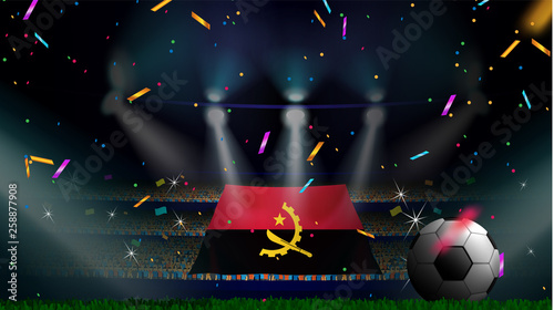 Fans hold the flag of Angola among silhouette of crowd audience in soccer stadium with confetti to celebrate football game. Concept design for football result template