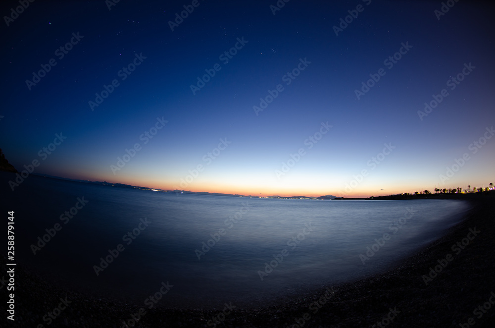 Fototapeta premium Afternoon Sunset, dark sky with stars