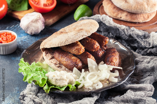 Cevapcici or cevapi served with lepinja bread photo