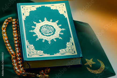 Holy islamic book Koran on the draped table with a rosary. Ramadan Kareem beautiful poster, banner, postcard for the celebration of the festival of the Muslim community photo