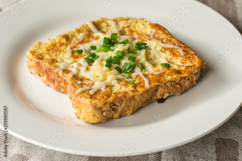 Savoury cheesy French toast with chives garnish close up - horizontal photo