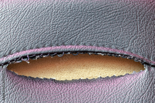 closeup of leather motorcycle seat damage.