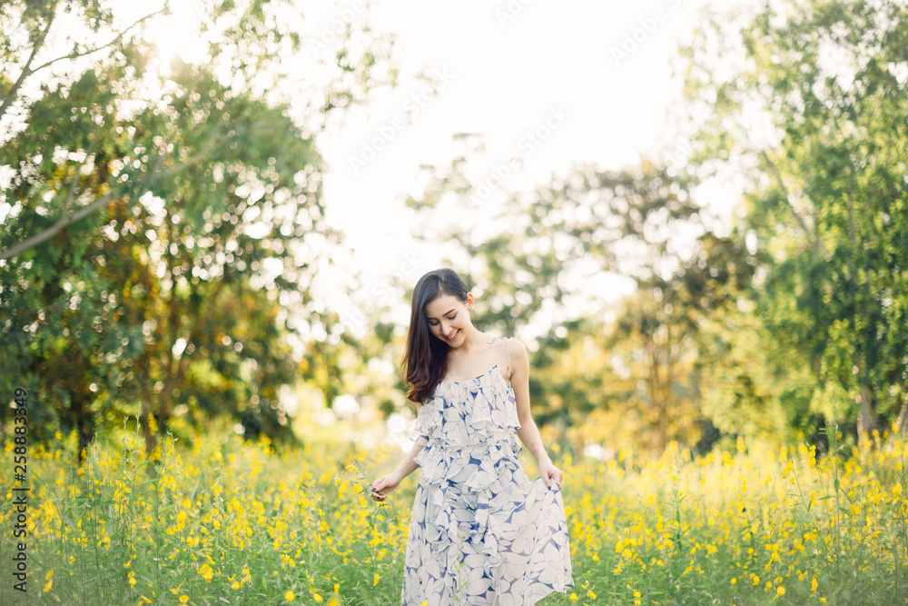 happy young woman enjoying summer in yellow flower field happy young woman enjoying summer in yellow flower field