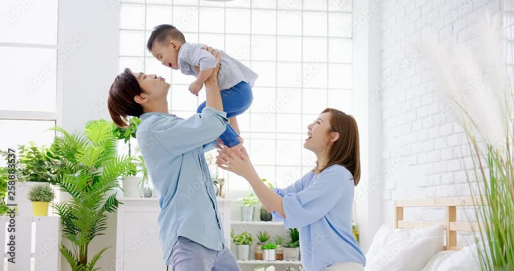 Happy family kiss their child