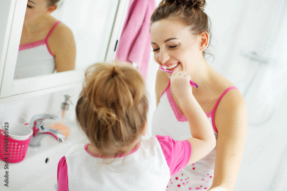 Woman and child brush their teeth Woman and child brush their teeth