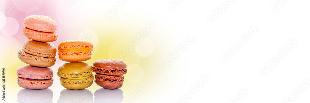 Stack of pastel colored french macarons, bokeh panoramic background