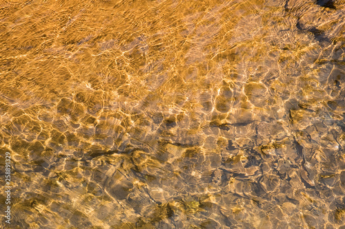 Top view pattern of water on the stone that is affected from light distortion.