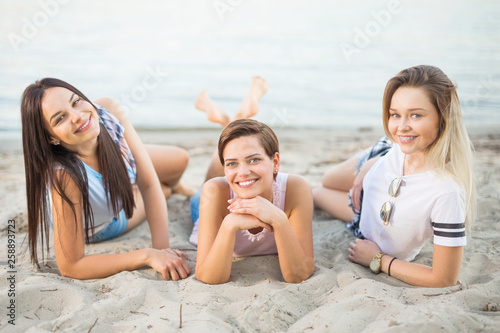Three beautiful and happy girlfriends at the beach